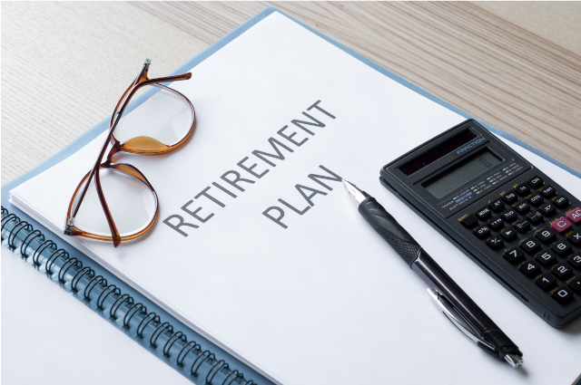 A retirement planning document on a desk alongside a calculator, pen, and glasses. Represents the financial groundwork essential for digital nomad retirement planning.