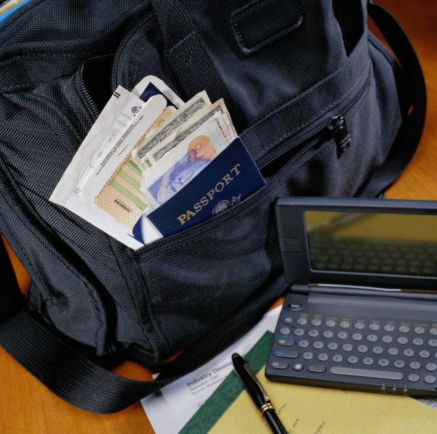 : A travel bag with a passport, foreign currency, and travel documents peeking out of a pocket.