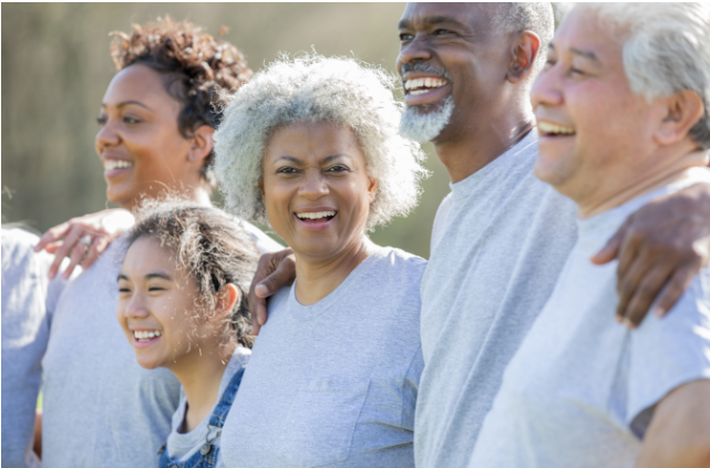 Group of volunteers of various ages connecting through community work, highlighting how volunteering builds social connections and strengthens community ties.
