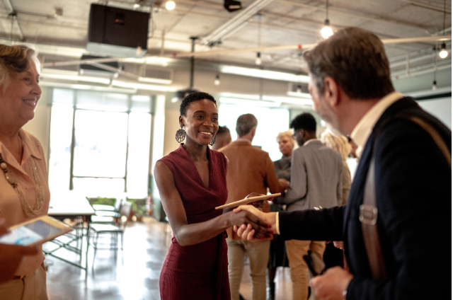 A lively scene of professionals networking and exchanging ideas.